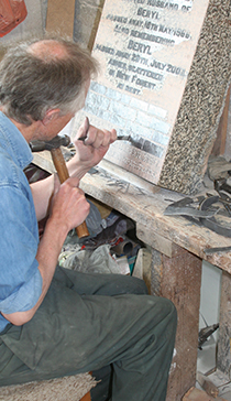 One of our masons hand-cutting lettering with mallet and chisel