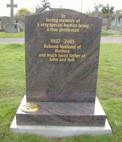 Grey granite headstone with gold lettering, fixed in a churchyard