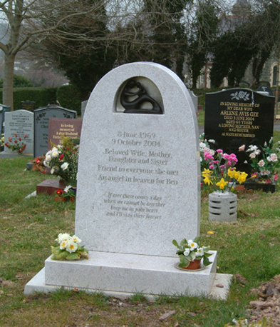 White marble headstone with an oval recess
