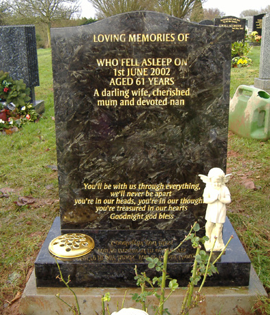 Black granite headstone with gold lettering and a cherub